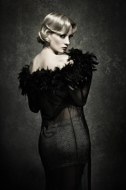 istock woman posing in feather boa - retro style 143918140