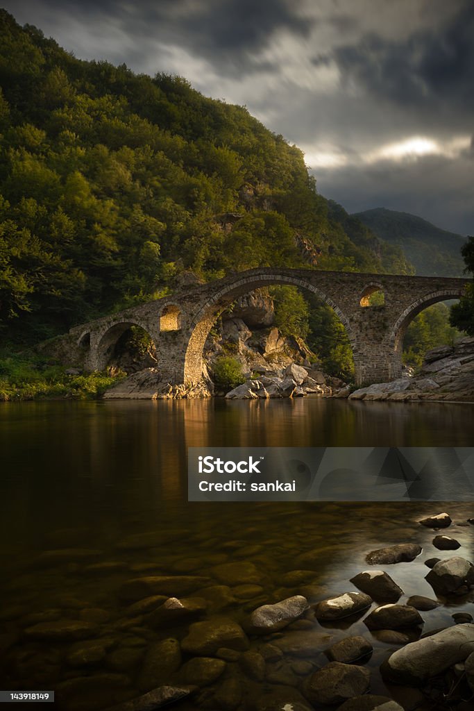 Twilight-dessus de la rivière de montagne et ancien pont gothique - Photo de Alpes européennes libre de droits