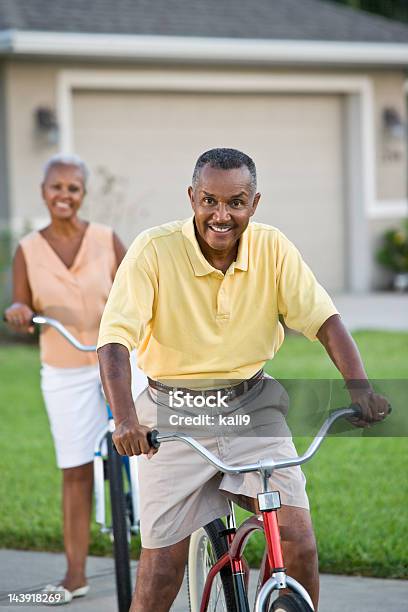 Senior African American Couple Riding Bicycles Focus On Man Stock Photo - Download Image Now