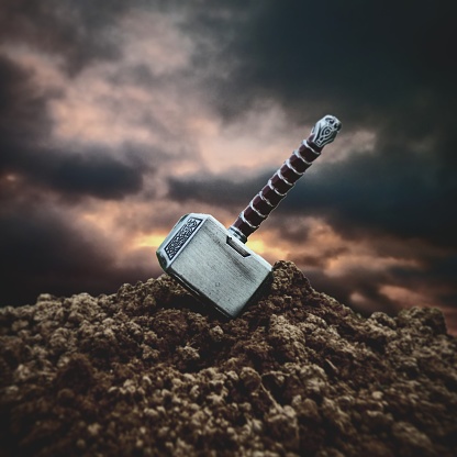 A close up shot of the hammer of Thor stuck in the ground
