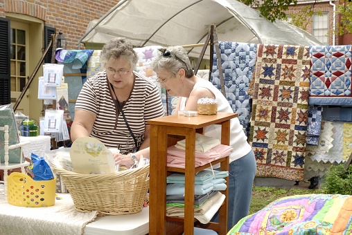 St. Charles, United States – September 12, 2008: Women looking at patterns at a quilt show in Missouri.
