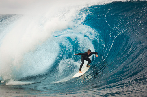 Surfer dropping in late under the lip Oahu