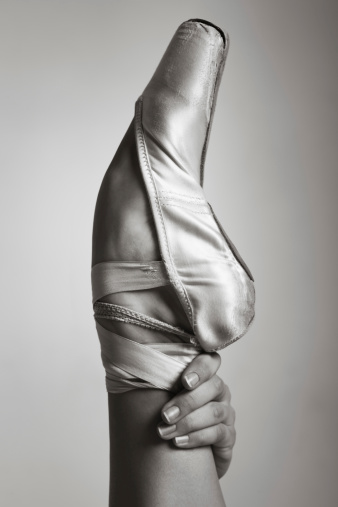 Professional ballerina's foot in shabby working pointe.