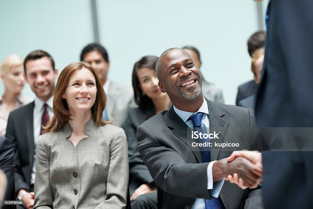 Business partners shaking hands during conference  40-49 Years Stock Photo