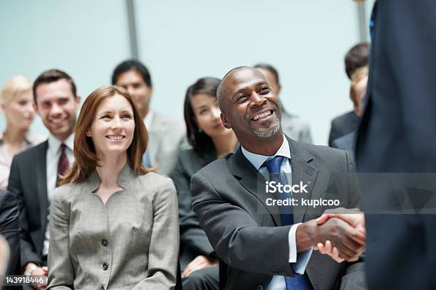 Business Partners Shaking Hands During Conference Stock Photo - Download Image Now - 40-49 Years, Adult, Adults Only