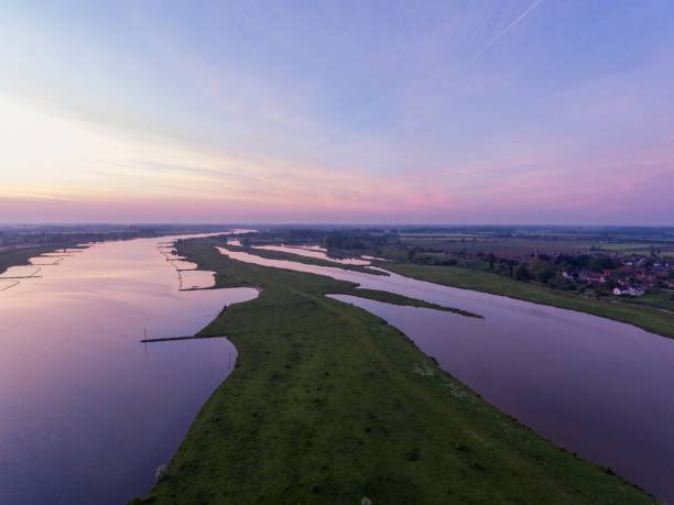The Lek River surrounded by the Everdingen Village during a beautiful sunset in the Netherlands A landscape of the Lek River surrounded by the Everdingen Village during a beautiful sunset in the Netherlands lek river in the netherlands stock pictures, royalty-free photos & images