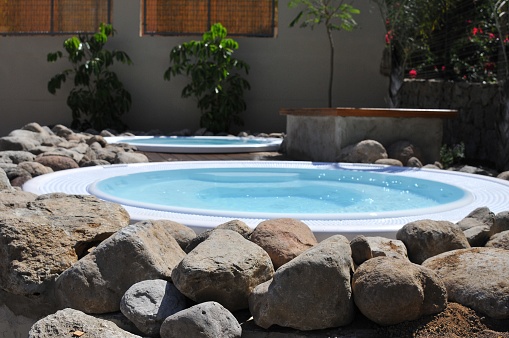 A beautiful shot of small round inground swimming pools under the sunlight