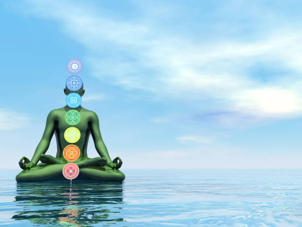 istock Man meditating upon the ocean and chakra colors - 3D render 1439185498