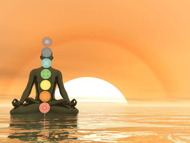 istock Man meditating upon the ocean and chakra colors - 3D render 1439185504