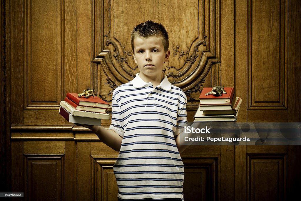 School boy castigados sosteniendo libros - Foto de stock de Incómodo libre de derechos