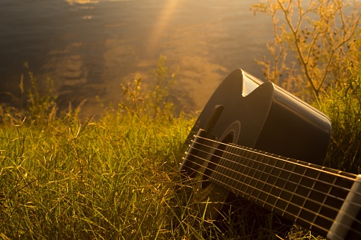 A high angle shot of a guitar on the grass - perfect for background