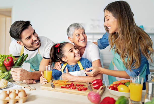 Happy family cooking together in a kitchen stock photo