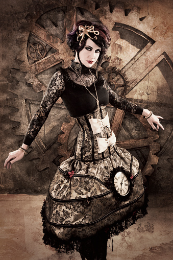 A beautiful young woman in a designer steampunk dress against a grungy industrial background. Texture overlay and noise added for artistic effect.