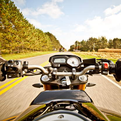 Riding motorcycle on country road during first days of Fall. Shot wide angle with 5DII.