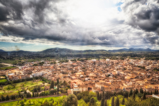 view on the old spanish town of Arta (Majorca/Spain) - sunbeam breaking through the dramatic sky