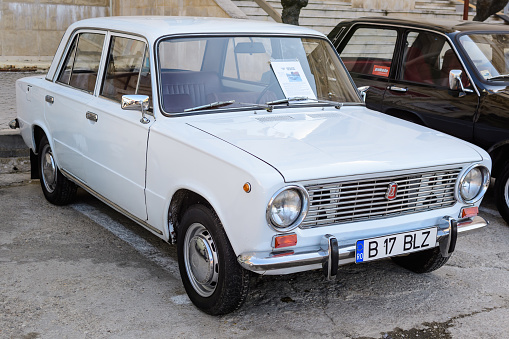 Bucharest, Romania, 2 October 2021: One white Lada 1200 vintage car produced in year 1980 and parked in a street at an event for vintage cars collections, in a sunny autumn day