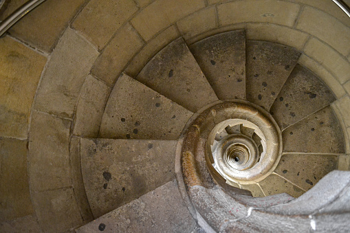 Top view of the spiral staircase in the tower. Walking down old the winding stairs