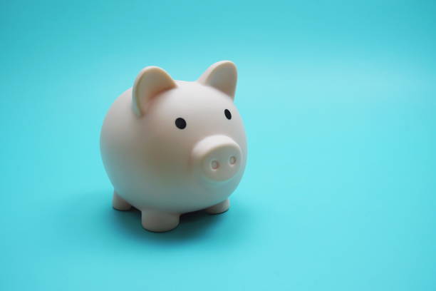 istock Piggy Bank Saving finance concept on blue background 1439193695