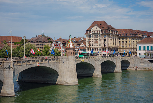 BASEL, SWITZERLAND, JULY 7, 2022: bridge Wetsteinbrucke over Rhine river and historical Buildings in the town. walk through old well-preserved city in Europe.