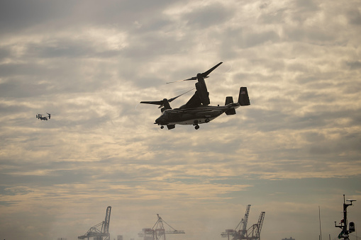 Miramar, California, USA - September 24, 2023: A Marine Corps CH-53, appears in the distance through the smoke, during the Marine Air Ground Task Force (MAGTF) Demstration at the 2023 America's Airshow.
