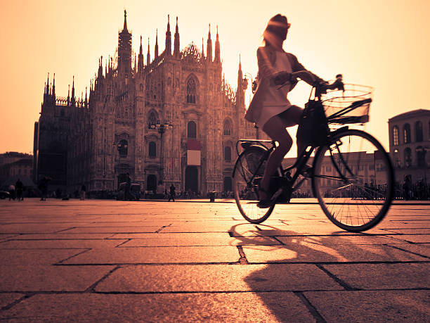 Riding A Bicycle In Milan City At Sunset stock photo