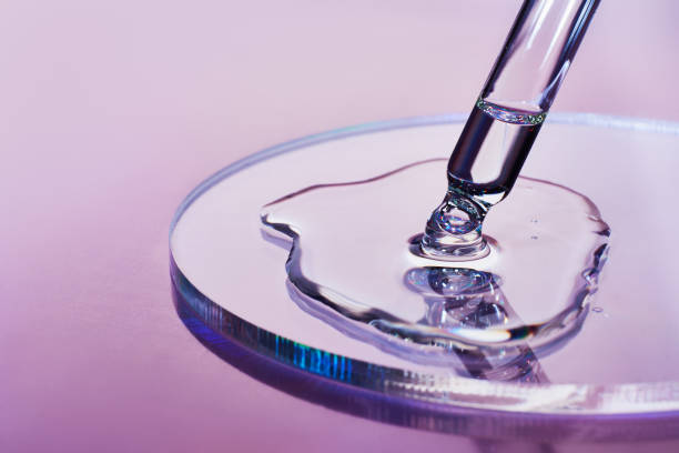 Pipette with sample of cosmetic product in petri dish on holographic background, iridescent highlights, selective focus Pipette with sample of cosmetic product in petri dish on holographic background, iridescent highlights, selective focus. makeup product photography stock pictures, royalty-free photos & images