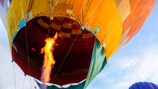 istock Strong fire blast pointed into the colourful hot air balloon 1439196841