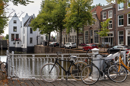 Canal houses in the center of Gouda with a view of the toll house in the Netherlands.