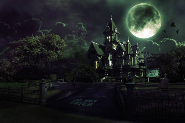 Full Moon Over Haunted House with Graveyard for Halloween Dark image of a haunted house with clouds and mountains in the background. Includes graveyard, full moon, and crows flying across moon. Copy space. CLICK FOR SIMILAR IMAGES AND LIGHTBOX WITH SEASONAL IMAGES. spooky stock pictures, royalty-free photos & images