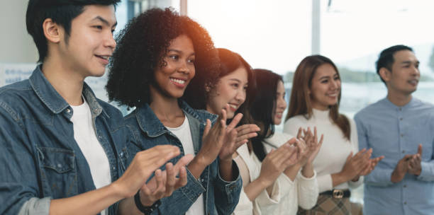 istock Happy young creative business team applauding after successful meeting 1439197108