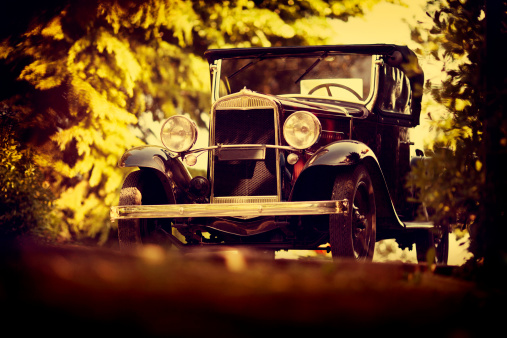 old italian car from the 20s parked, processed to simulated fall colors