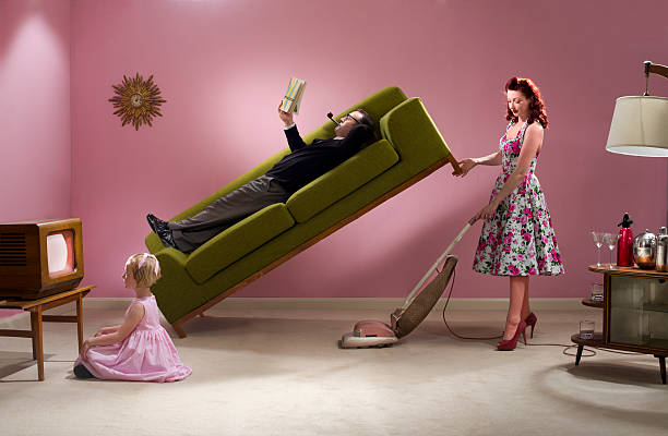 super housewife 1950s glamorous housewife cracks on with the cleaning  couch potato photos stock pictures, royalty-free photos & images