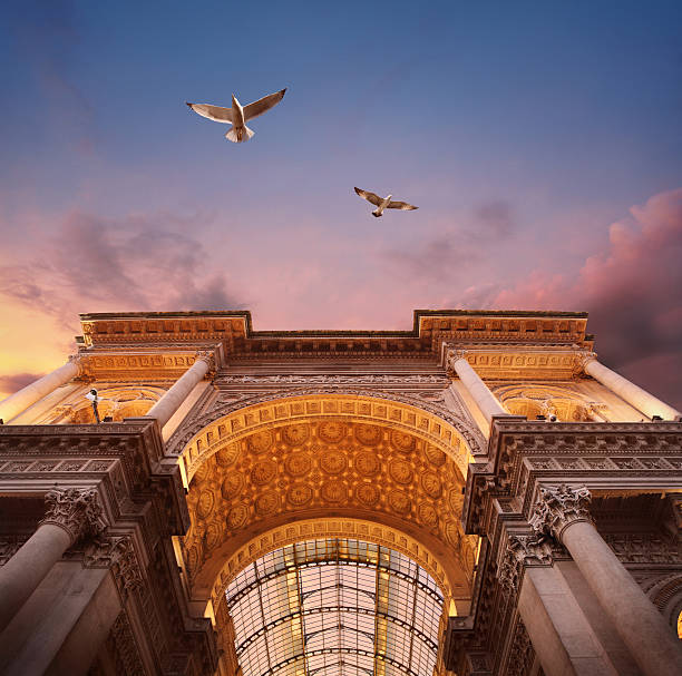 Galleria Vittorio Emanuele II in Milan Galleria Vittorio Emanuele II at Piazza del Duomo in Milan in sunset light, photomontage. See my other photos from Italy: :  http://www.oc-photo.net/FTP/icons/italy.jpg galleria vittorio emanuele ii stock pictures, royalty-free photos & images