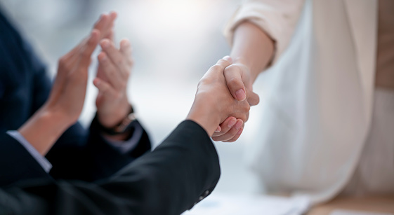 Business people handshake for teamwork of business merger and acquisition, two businessman shake hand with partner to celebration business deal.