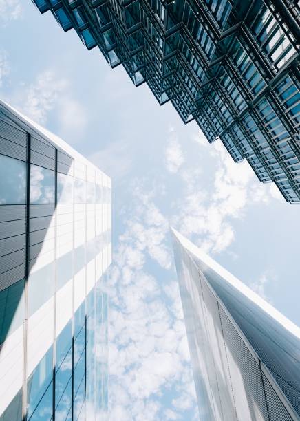 istock Low angle vertical shot of modern architectural buildings with a cloudy blue sky in the background 1439199635