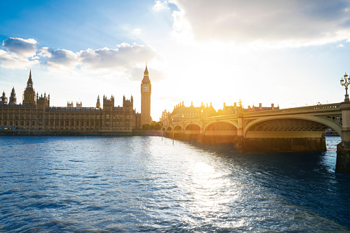 London Big Ben clock and Houses of Parliament in Westminster bridge on river Thames at sunset in UK Great Britain United Kingdom, England at the evening dusk