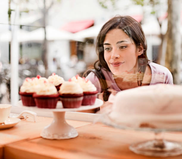 istock Woman looking at cake display in window 143920088
