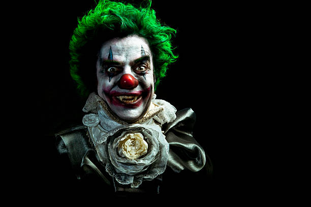 An extreme close up of a creepy clown.