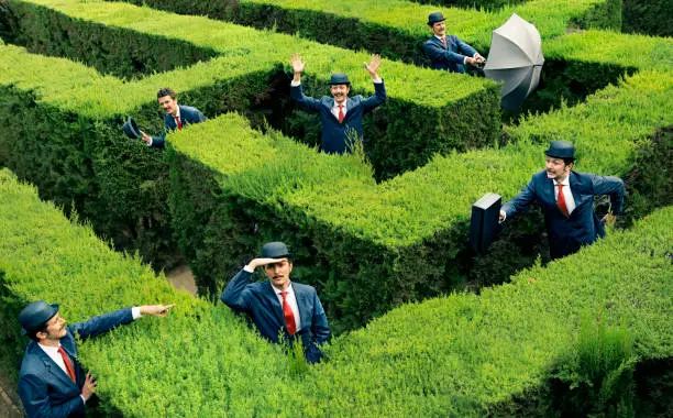 Classic business man looking for the way in a maze