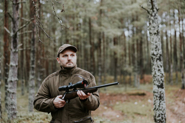 istock Man with hunting rifle in the autumn forest 1439202035