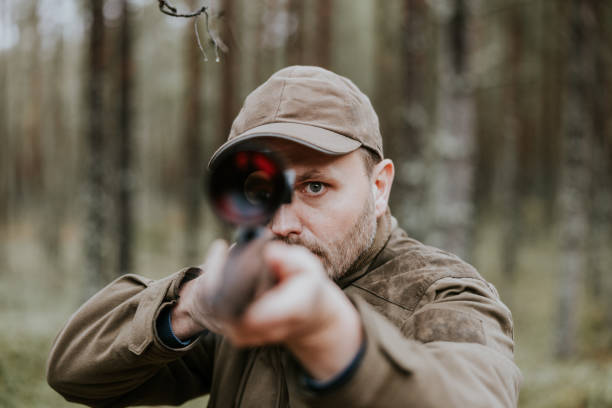 istock Man aiming with hunting rifle in the autumn forest 1439202039