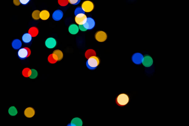 istock Clorful blurred lighs bokeh on black background as a festive backdrop 1439202215