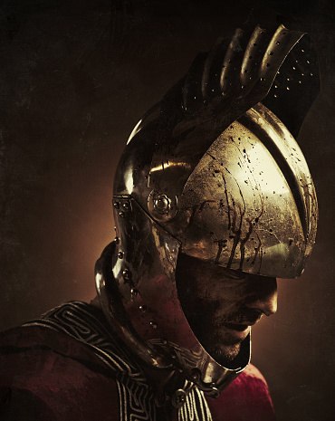 close up portrait of a knight after combat wearing a bloody open helmet and a red cape