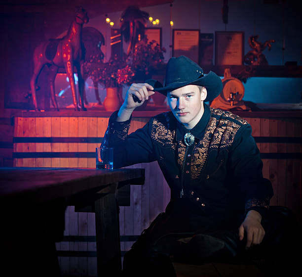 istock Cowboy at table in saloon 143920326