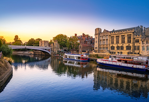 York UK Guildhall sunset in Lendal Bridge over river Ouse boats in England United Kingdom of North Yorkshire