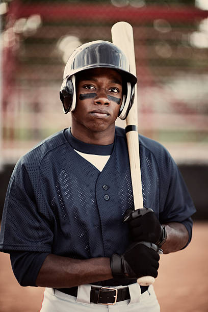 Baseball Player Portrait of an African American baseball player who is ready to mash the ball. baseball player photos stock pictures, royalty-free photos & images