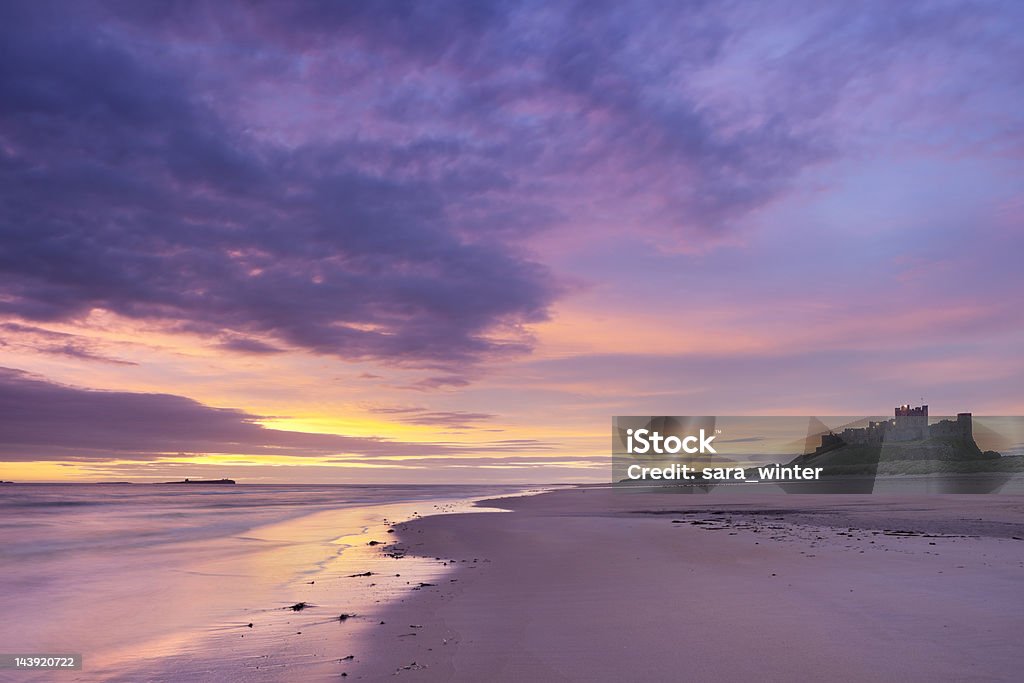 Sunrise on the beach at Bamburgh Castle, Northumberland, England  Bamburgh Stock Photo