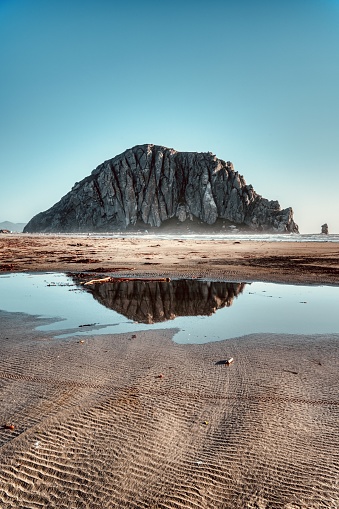 A shot of Morro Rock with a reflection pool.