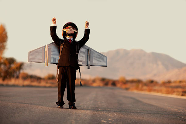 istock Young Boy Wearing Business Suit and Jet Pack on Blacktop 143920911