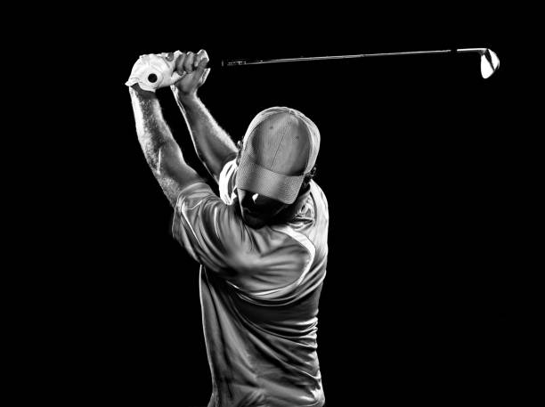 Dramatic Swing A b&w image of a golfer at the top of his swing. golf stock pictures, royalty-free photos & images